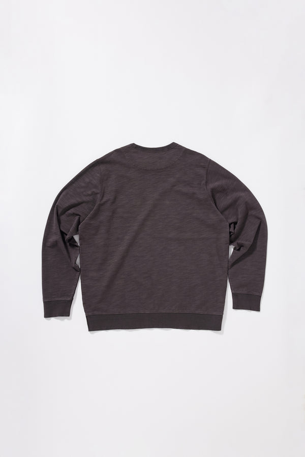 Back view of the washed black/ licorice relaxed long-sleeve T-shirt featuring a reinforced back yoke.