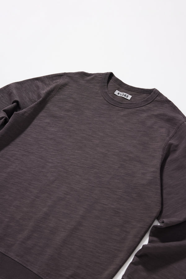 Close-up of the washed black/ licorice pigment-dyed slub cotton fabric showing its textured surface and soft finish.