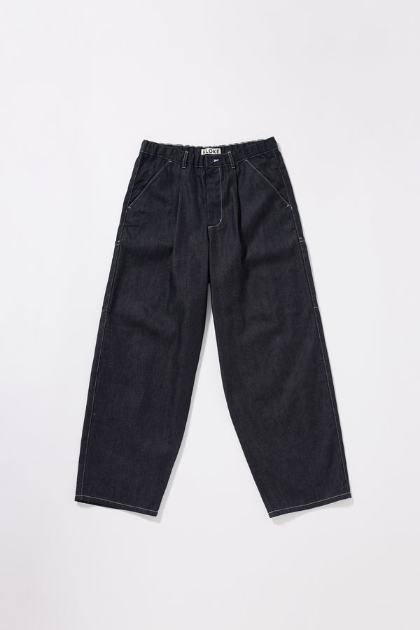 Flat front of the Lull Jean in dark indigo Japanese denim with a relaxed loose fit, cargo pockets and elasticated waistband.