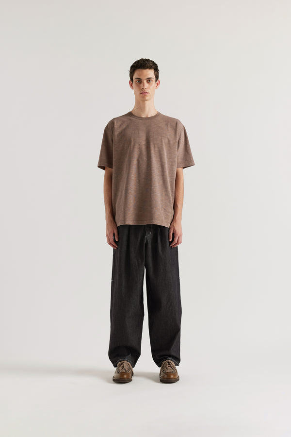 Front view of the Lull Jean in dark indigo Japanese denim with a relaxed loose fit, cargo pockets and elasticated waistband.