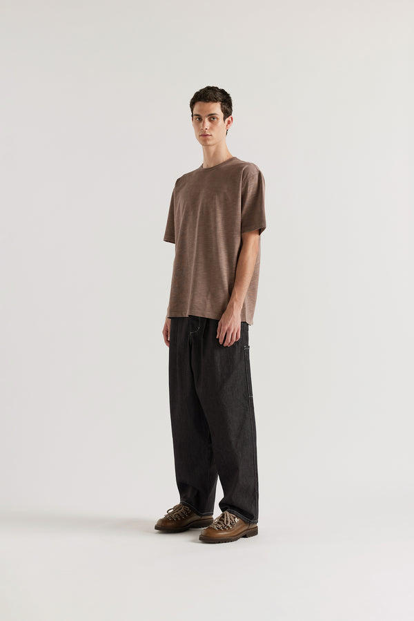 Front view of the Lull Jean in dark indigo Japanese denim with a relaxed loose fit, cargo pockets and elasticated waistband.