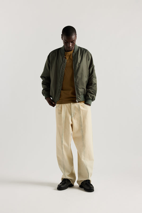 Front of model in the Olive Lyric Bomber Jacket in garment-washed nylon with zip front, tonal ribbing and multiple utility pockets.