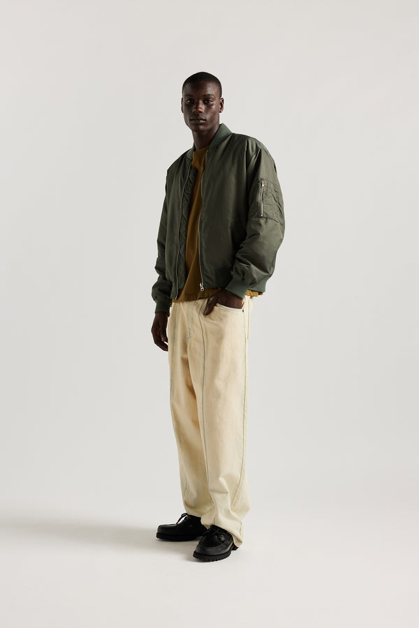 Front of model in the Olive Lyric Bomber Jacket in garment-washed nylon with zip front, tonal ribbing and multiple utility pockets.