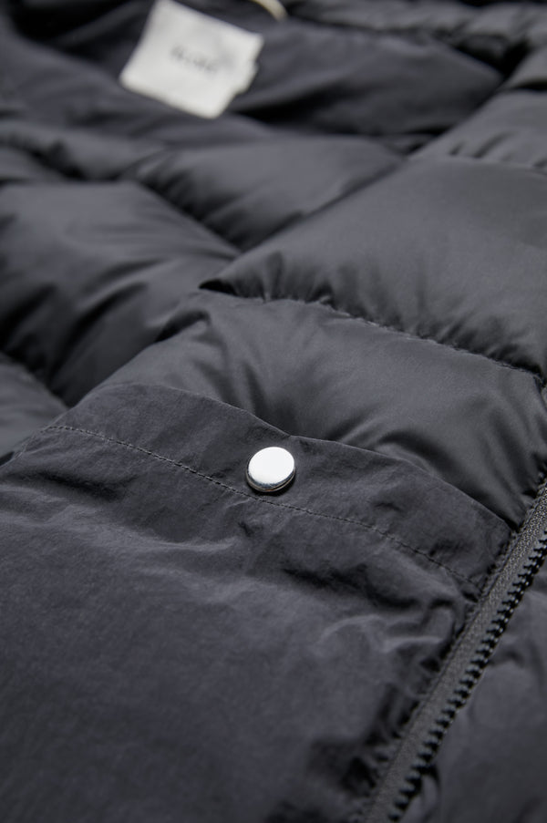 The Majority Quilted Puffer Jacket Black features an internal breast pocket with press-stud closure.