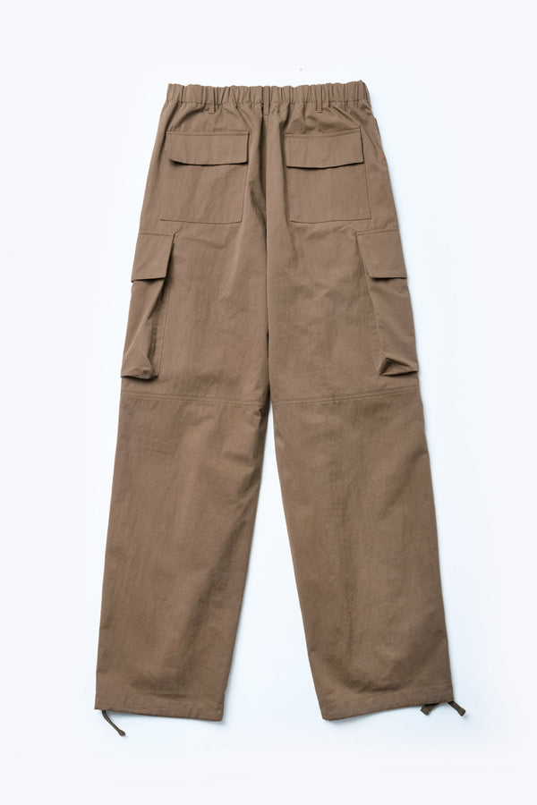 The back of the Modulate Cargo Pant Brown, a super-relaxed and sturdy cargo pant made from a mid-weight cotton drill. Featuring six pockets including feature flap and stud closing side pockets.