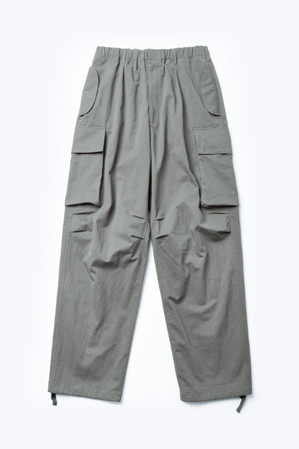 The front of the Modulate Cargo Pant is made from a mid-weight cotton drill in Grey. These classic cargo pants with a super-relaxed fit with 3D pockets and  an elastic waist with classic zip and press-stud fly closure.