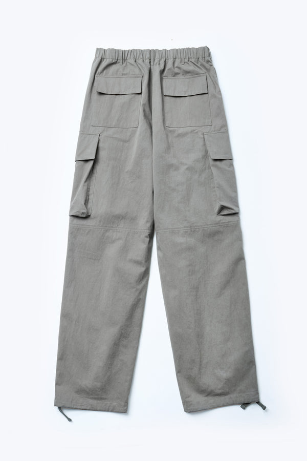 The back of the Modulate Cargo Pant Grey, a super-relaxed and sturdy cargo pant made from a mid-weight cotton drill. Featuring six pockets including feature flap and stud closing side pockets.
