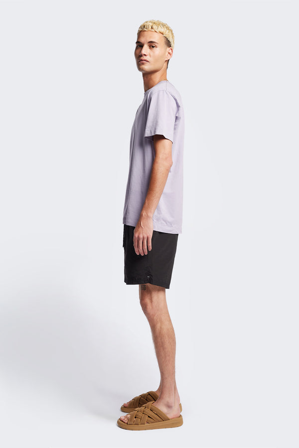 Side profile of the Radius T-Shirt Lilac, a traditional tee with a relaxed fit. Crafted from soft and durable high-grade organic cotton.