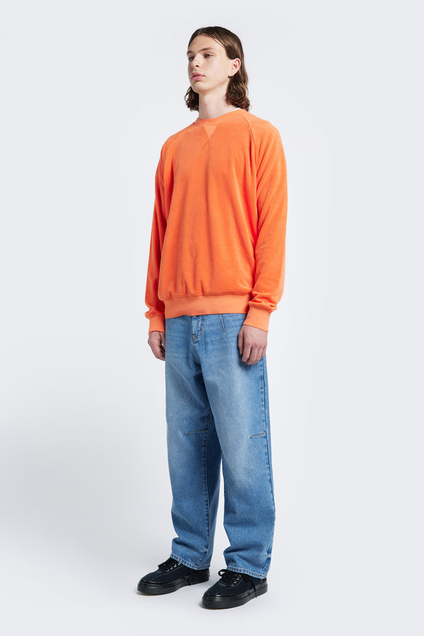 The Range Towelling Sweater made from plush, 100% cotton Okeo-tex standard 100 micro terry-towelling in Tangerine Orange. Featuring rib band trim, V insert, flatlock stitch and raglan coverstitched sleeve. 