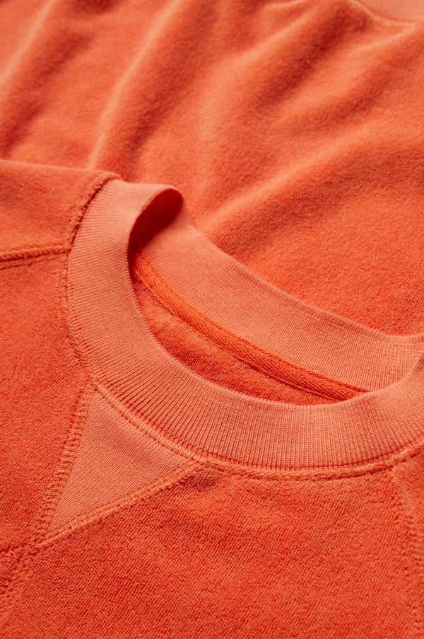 The Range Towelling is made from plush, 100% cotton Okeo-tex standard 100 micro terry-towelling in Tangerine Orange with a round neckline and triangle insert.