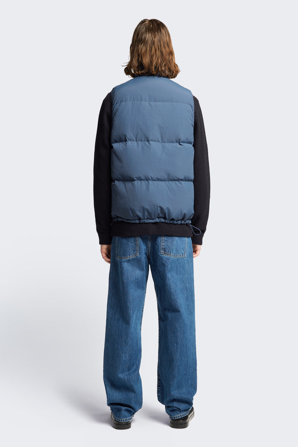The back of the Reset Quilted Puffer Vest Blue made with 100% post-consumer down fill.