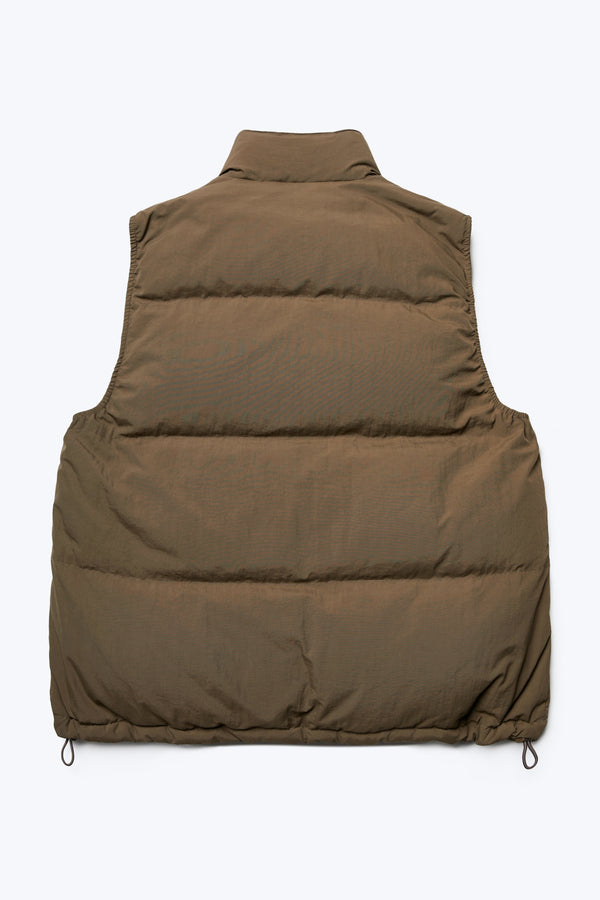 The back of the Reset Quilted Puffer Vest Brown made with 100% post-consumer down fill. Has a high neckline for warmth, elasticated arm holes for comfort and an adjustable toggled elastic waist. 