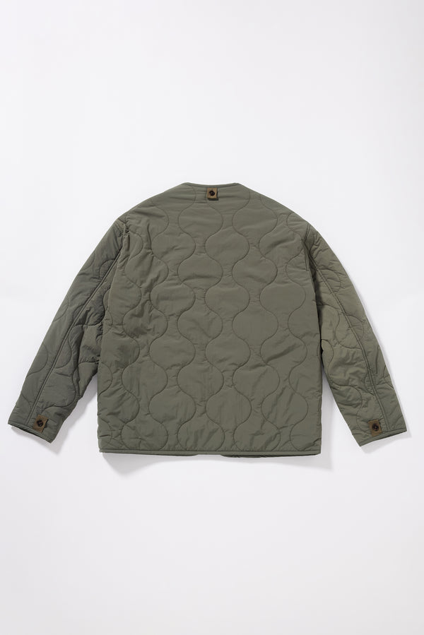 Flat back of the Olive ripple-patterned quilted stitching on recycled nylon reversible jacket
