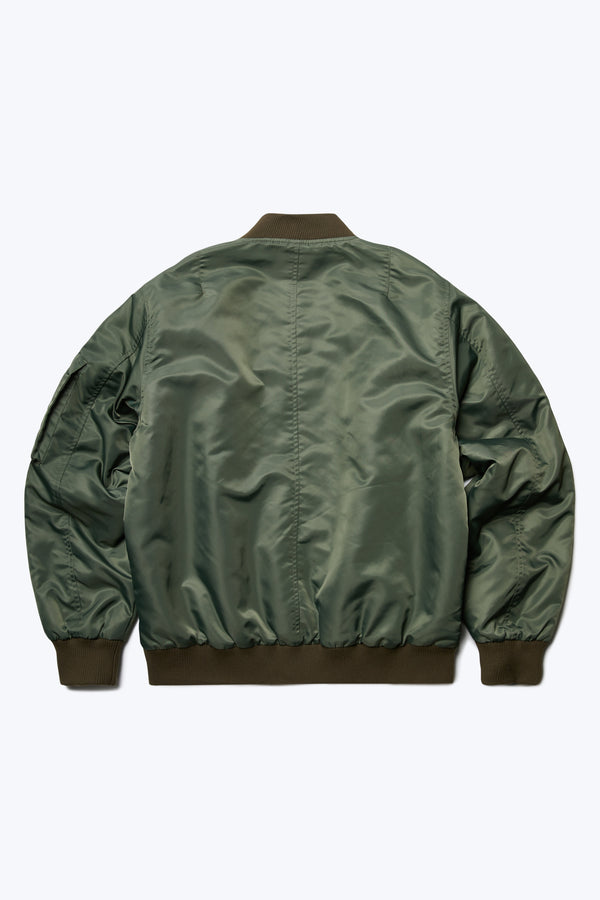 The back of the Bomber Jacket Olive Green, a lightweight nylon jacket with rib trim. This jacket is a homage to the original MA-1. 