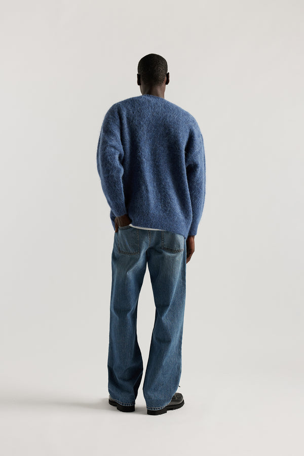 The sworn denim jean in Mid Blue Fade. Looser fit all-purpose jeans in premium Japanese denim with zip fly, button closure, five-pocket design, and Kloke branded hardware. Available in 8 sizes.