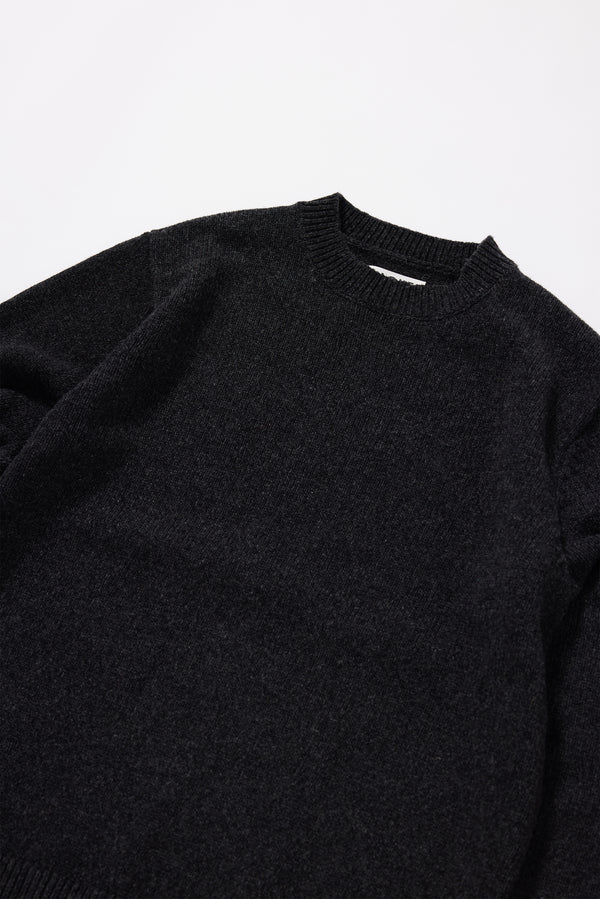 Close-up of the crew neckline on the Charcoal Vellum Knit Sweater in 100% extrafine RWS Merino