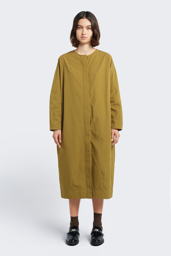 Model standing front on wearing the Agora Dress Moss Green with round neckline, concealed button-through placket at the front and darted detailing