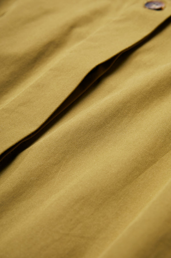 Close up of the concealed button-through placket at the front on the Agora Dress Moss Green.