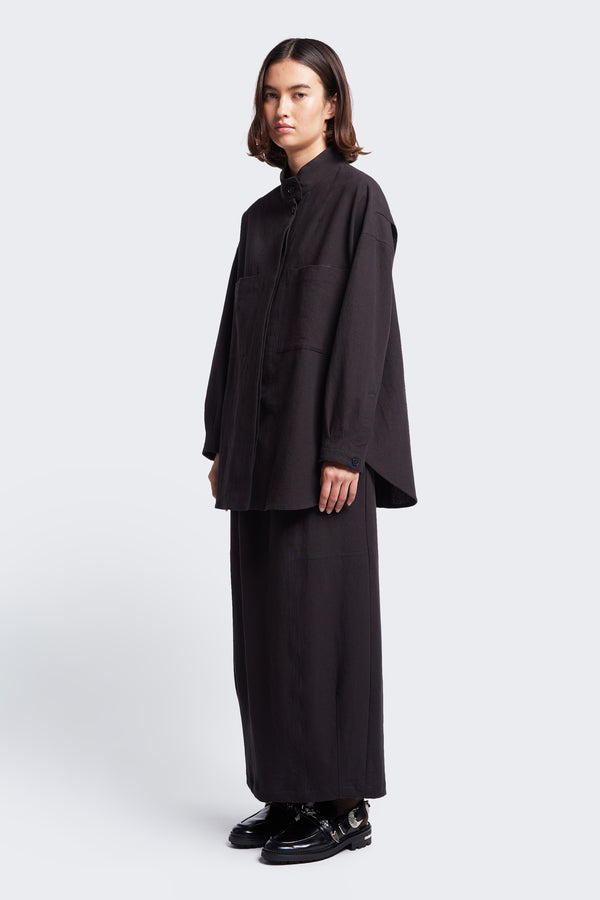 The Anima Skirt Black a long, straight style skirt with an elasticated waist. Styled with the Tenet Blouson Shirt Black.