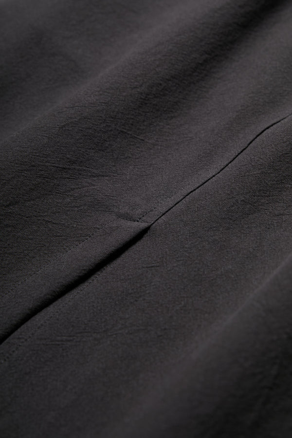 Close up of the Anima Skirt Black, cut from soft textural cotton and featuring a back centre split.