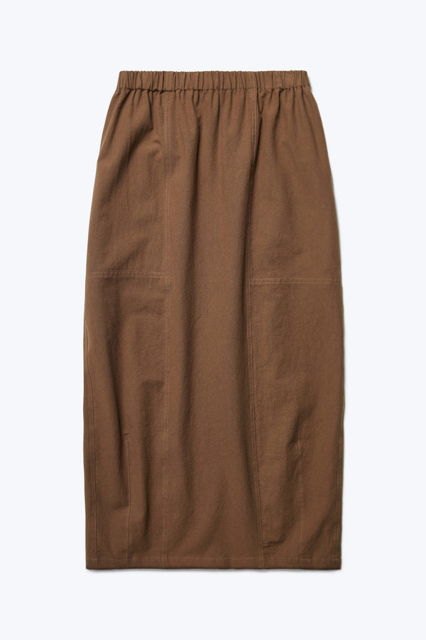 The front of the Anima Skirt Brown, a long, straight style skirt with elasticated waistline, darted panels and straight hem.