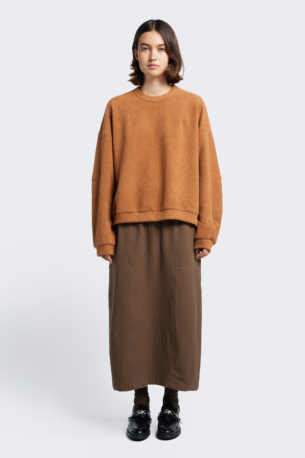 The Anima Skirt Brown, a long, straight style skirt, with an elasticated waist. Crafted from soft textural cotton with darted panels. 