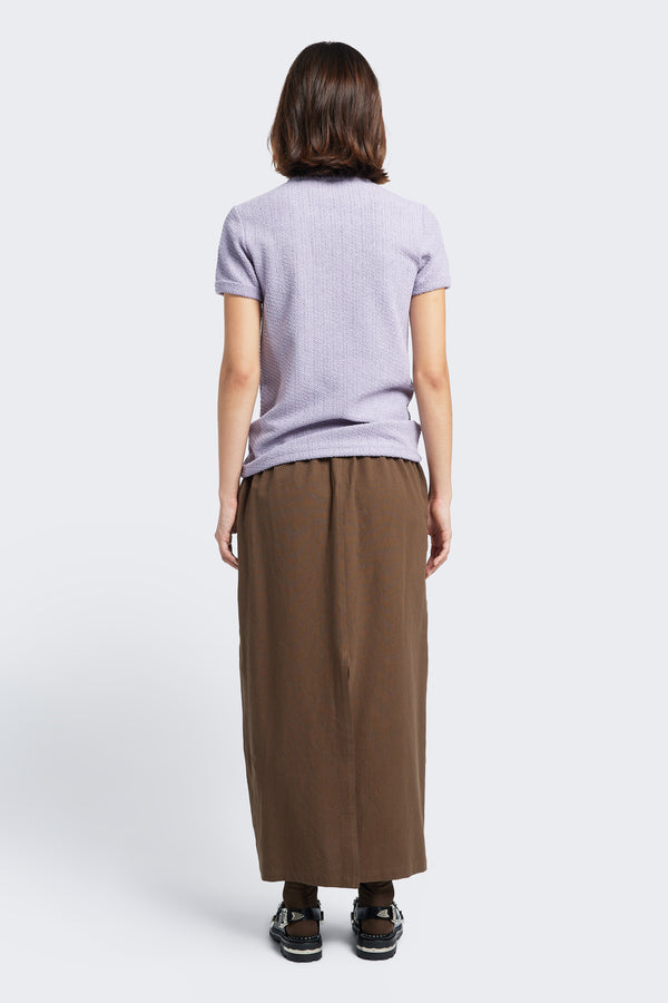 The back of the Anima Skirt Brown, a straight style skirt with straight hem and a back centre split.