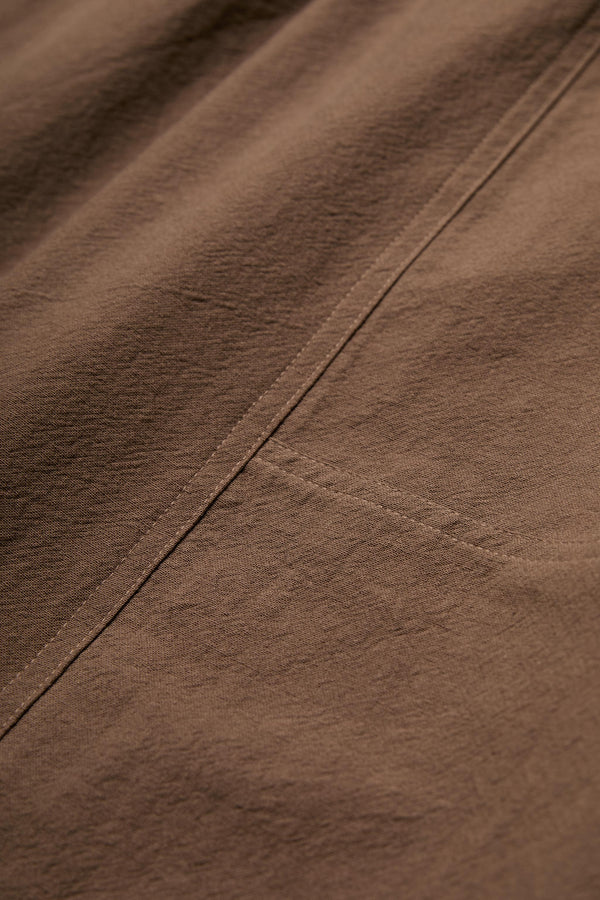 Close up of the Anima Skirt Brown crafted from a soft textural cotton with darted panels.