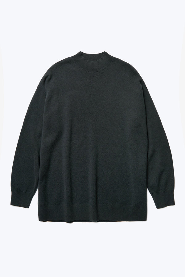 The Buro Knit Sweater Charcoal is a mock neck merino sweater crafted in a milano knit structure with hints of deep forest green.