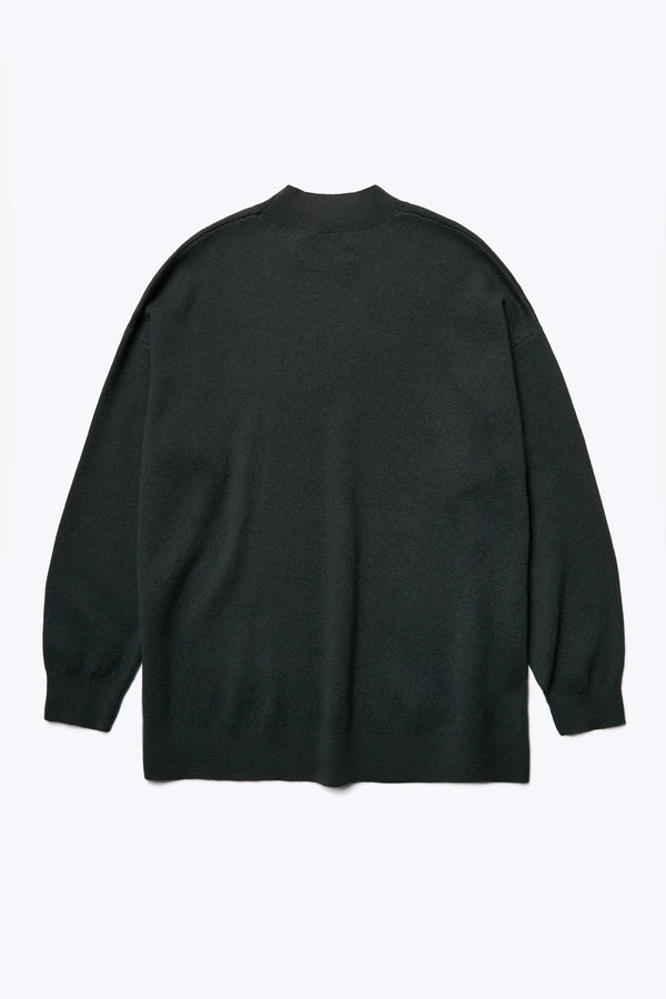 The back of the Buro Knit Sweater Charcoal is a mock neck merino sweater crafted in 100% Merino wool and accented with a dropped shoulder and long line of the body, finishing just below the hips with a 1x1 rib hemline. 