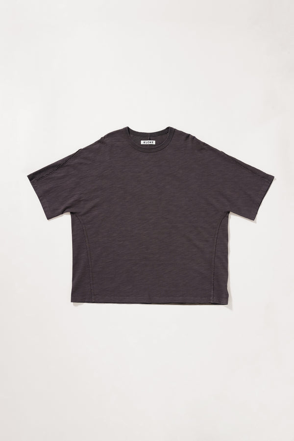 Flat front of the brown Overdyed Declare Tee in black licorice with a relaxed boxy fit and twisted sleeve detailing.