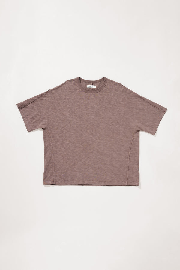 Flat front of the brown Overdyed Declare Tee in Nut Brown with a relaxed boxy fit and twisted sleeve detailing.