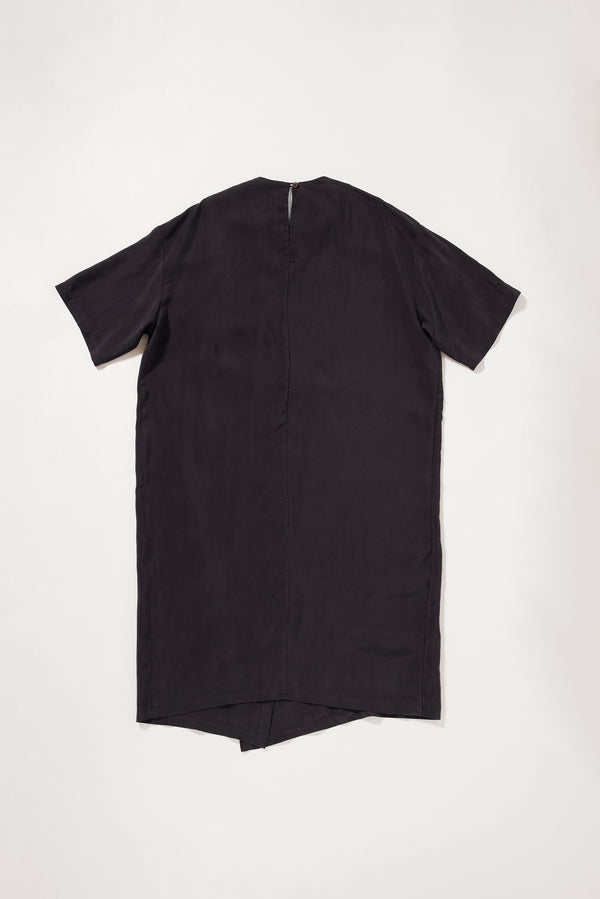 Flat back of the Eon Dress in vintage black  showing fluid midi silhouette and double-layered asymmetric split front.