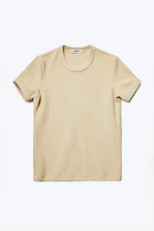 The front of the Exodus Tee Butter, a classic slim fit ringer t-shirt in thick jersey with a textured loop weave for a brushed finish. This top is an elevated alternative to an everyday tee.