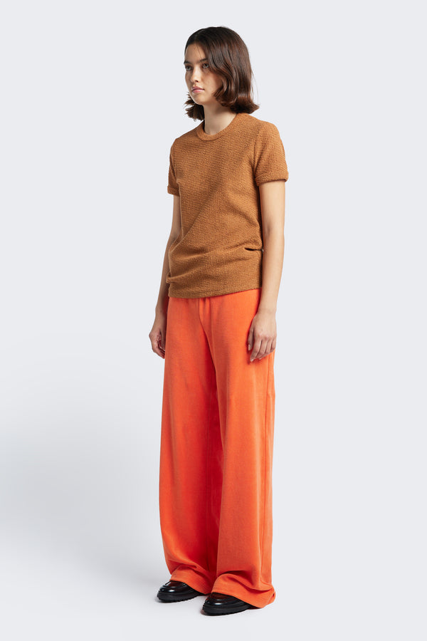 The Exodus Tee Rusty Brown, a classic slim fit ringer t-shirt in thick jersey, styled with the Prone Towelling Track Pant Tangerine. 