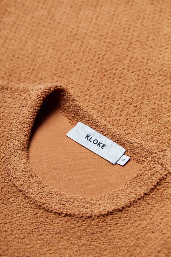 Close up of the thick jersey fabric on the Exodus Tee Rusty Brown. This thick jersey has a textured loop weave for a brushed finish.