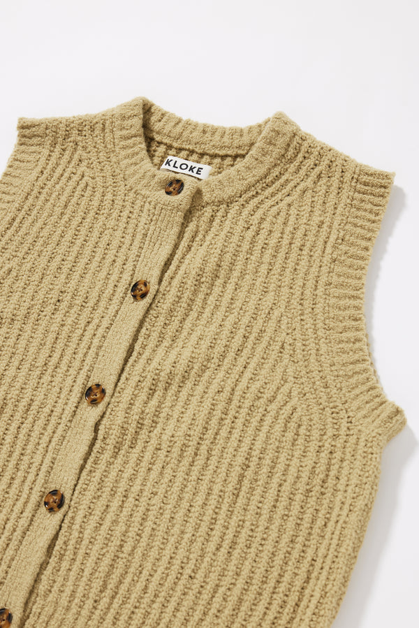 Close-up of the tubular rib neckline and centre-front button placket on the Faint Knit Vest  in Chartreuse