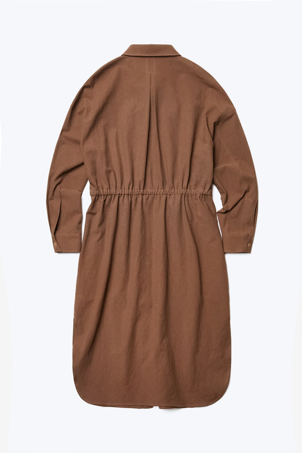 The back of the Filter Dress. Made from 100% cotton in Brown. This classic style has long sleeves, built in collar, waist ties, rounded scoop hemline and in seam side pockets.