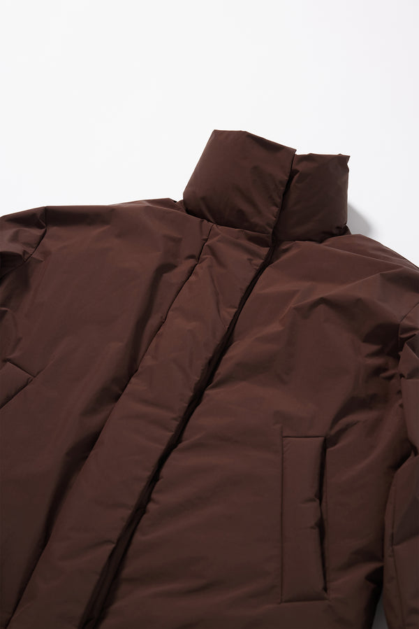 Close-up of the down-filled high collar and centre-front zip with magnetic fastenings on the Dark Chocolate Brown Floating Puffa Coat