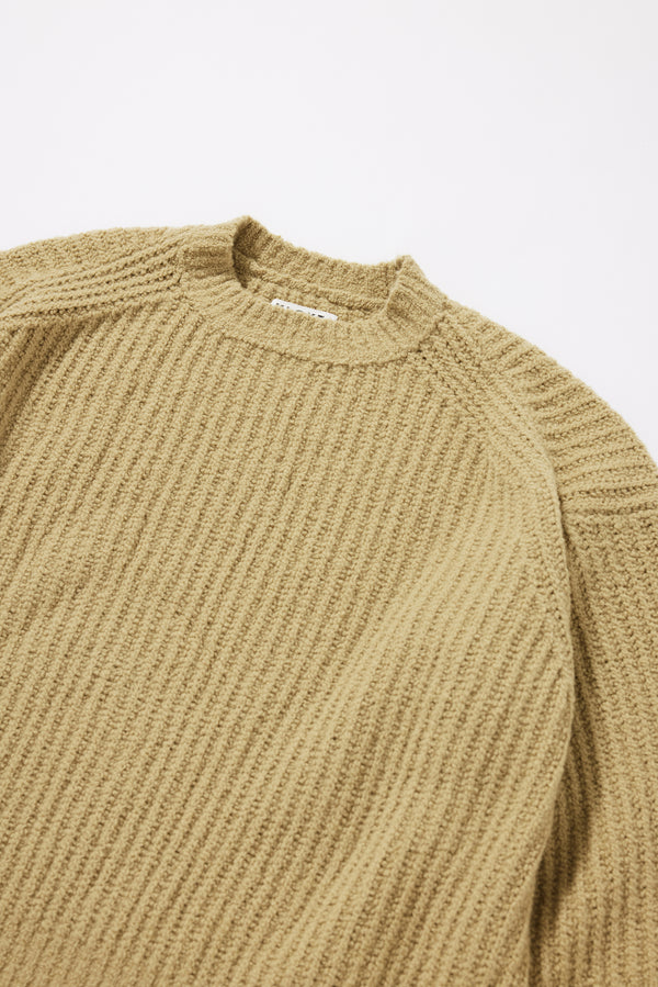 Close-up of the dense reverse half-cardigan rib knit texture on the Chartreuse Flutter Sweater in RWS certified Merino and recycled nylon