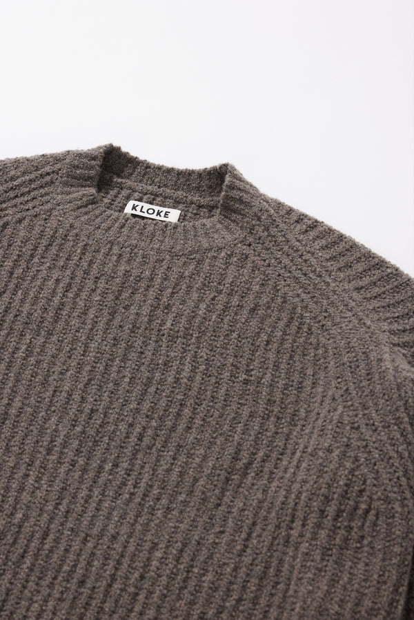 Close-up of the dense reverse half-cardigan rib knit texture on the Pale Pewter Flutter Sweater in RWS certified Merino and recycled nylon