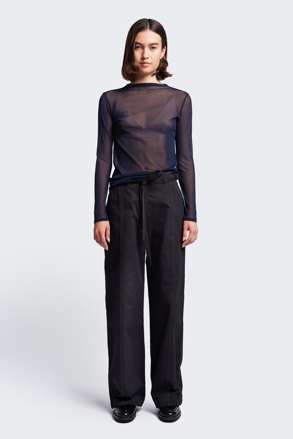 The Found Tie Front Pant Black with Brown Stitch, a relaxed, straight-leg pant, crafted from a durable cotton. Styled with the Exist Long Sleeve Mesh Top. 