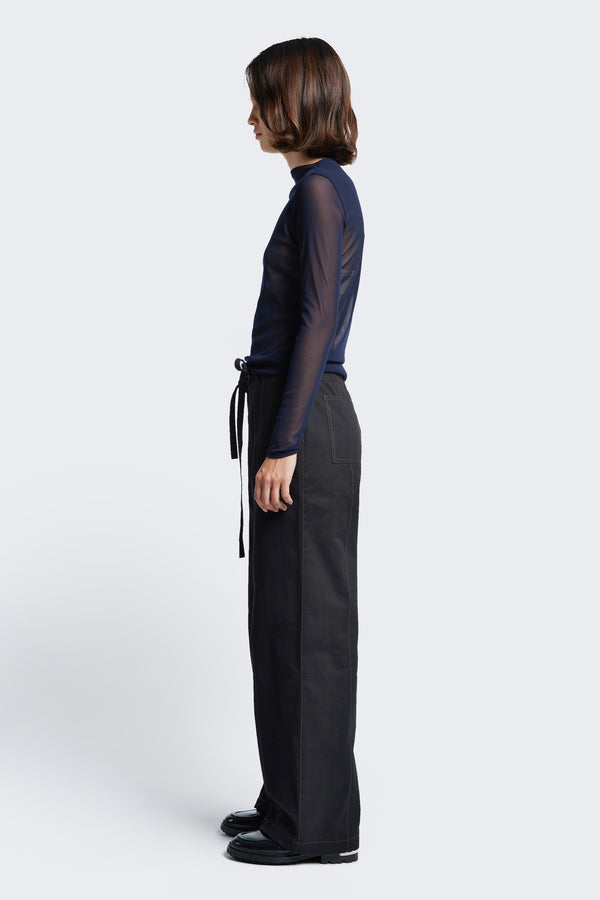 Side profile of the Found Tie Front Pant Black, complete with contrast topstitch, patch pockets at the rear, and diagonal seam pockets at the front.