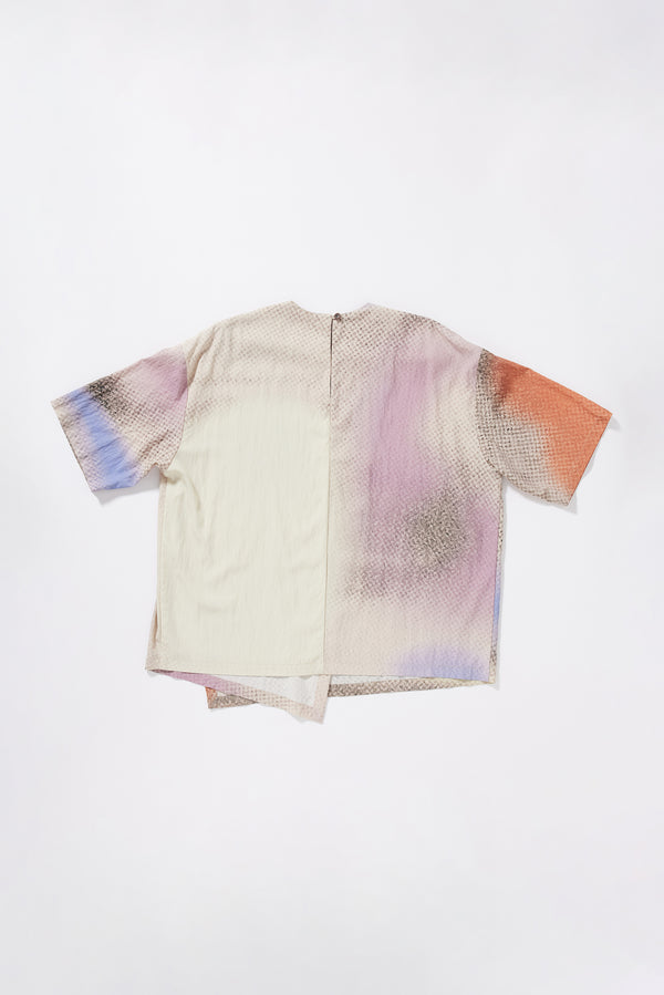 Flat Back view of the Glimmer Top in Aion Print showing hip length, short-to-mid sleeves and fragmented asymmetric deity print in mauve, blue and orange