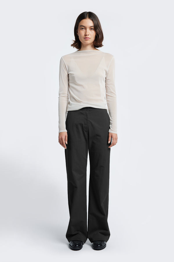 The Grace Pant Black, a slim, straight leg pant with a mid-rise waistline. Crafted from a linen-cotton blend and finished with tailored welt pockets at the rear and gently angled side pockets. 