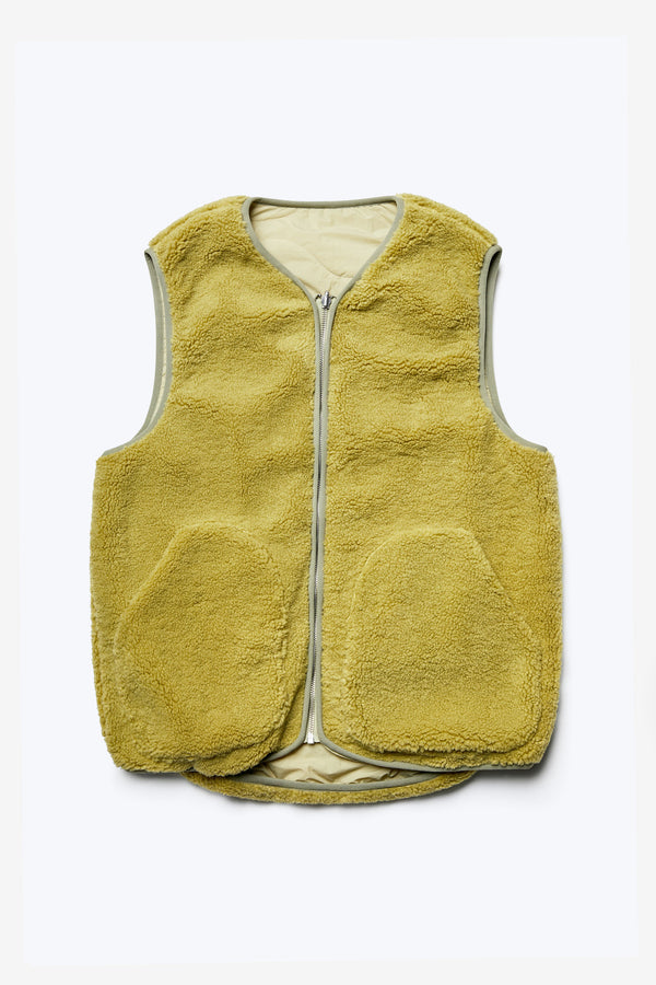 The Hearth Shearling Reversible Vest with a warming faux shearling fabrication in Chartreuse with a centre front zip closure. Available in five sizes.