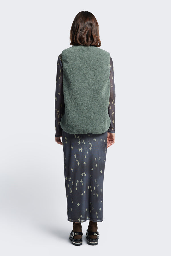 The back of the Hearth Shearling Vest with faux shearling fabrication in Petrol Green.