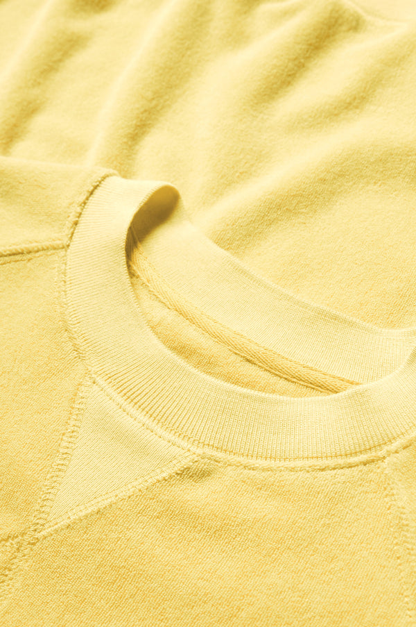 The Hero Towelling Sweater Butter Yellow is made from plush, 100% cotton Okeo-tex standard 100 micro terry-towelling with a round neckline and triangle insert.