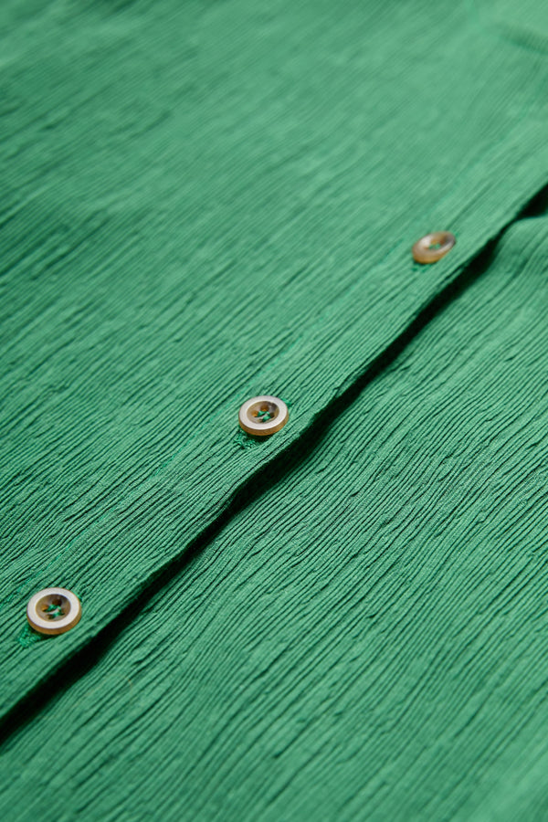 Close up of the centre front button through on the Hideout Crinkle Top Green. 