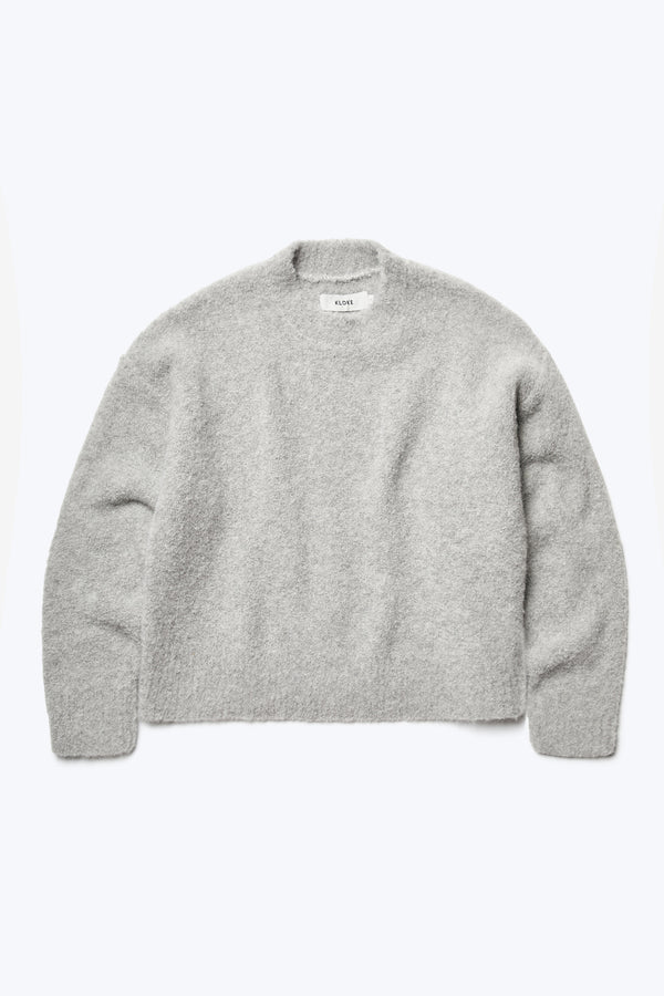 Flat lay of the Hold Shearling Sweater Soft Grey, made from a special Alpaca blend thats soft and warm. A flattering silhouette with cropped hem and dropped shoulder.